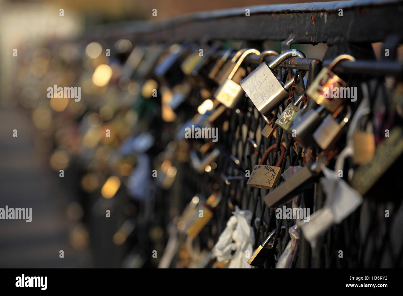 Love padlocks affixed to the railing fence of Pont de l'Archeveche ...