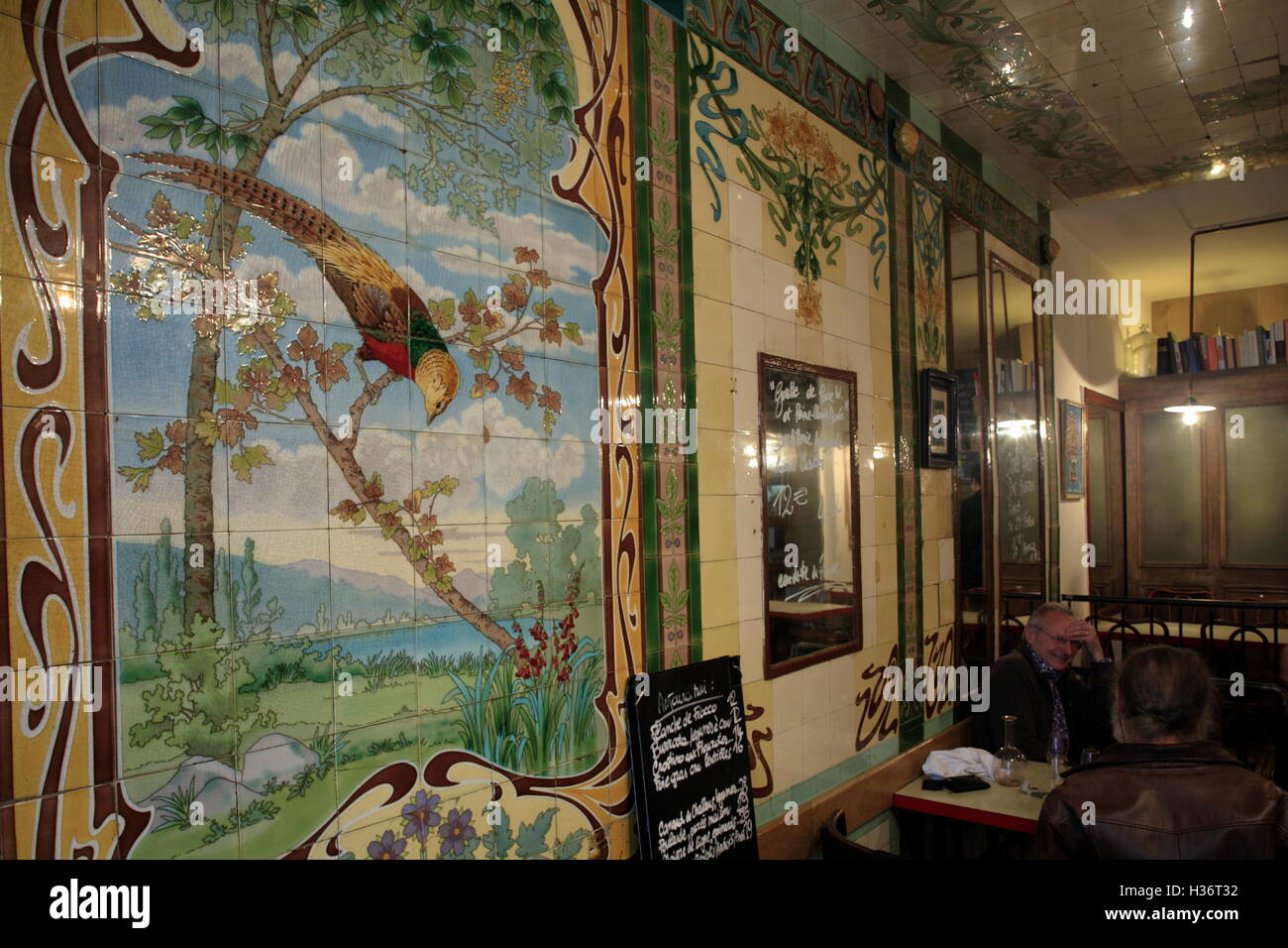 Restaurant Vivant with Art Nouveau style tiles decorations from a previous exotic bird shop in early 20th century,Paris,France Stock Photo