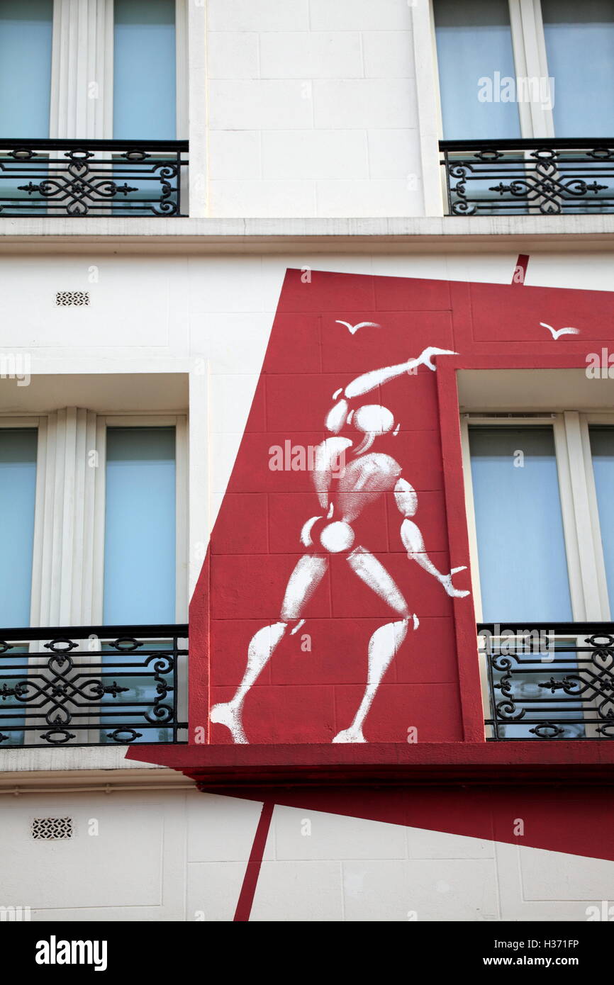 Graffiti artist Jerome Mesnager's 'White Bodies' decorating the facade of Hotel des Academies et des Arts. Paris. France Stock Photo