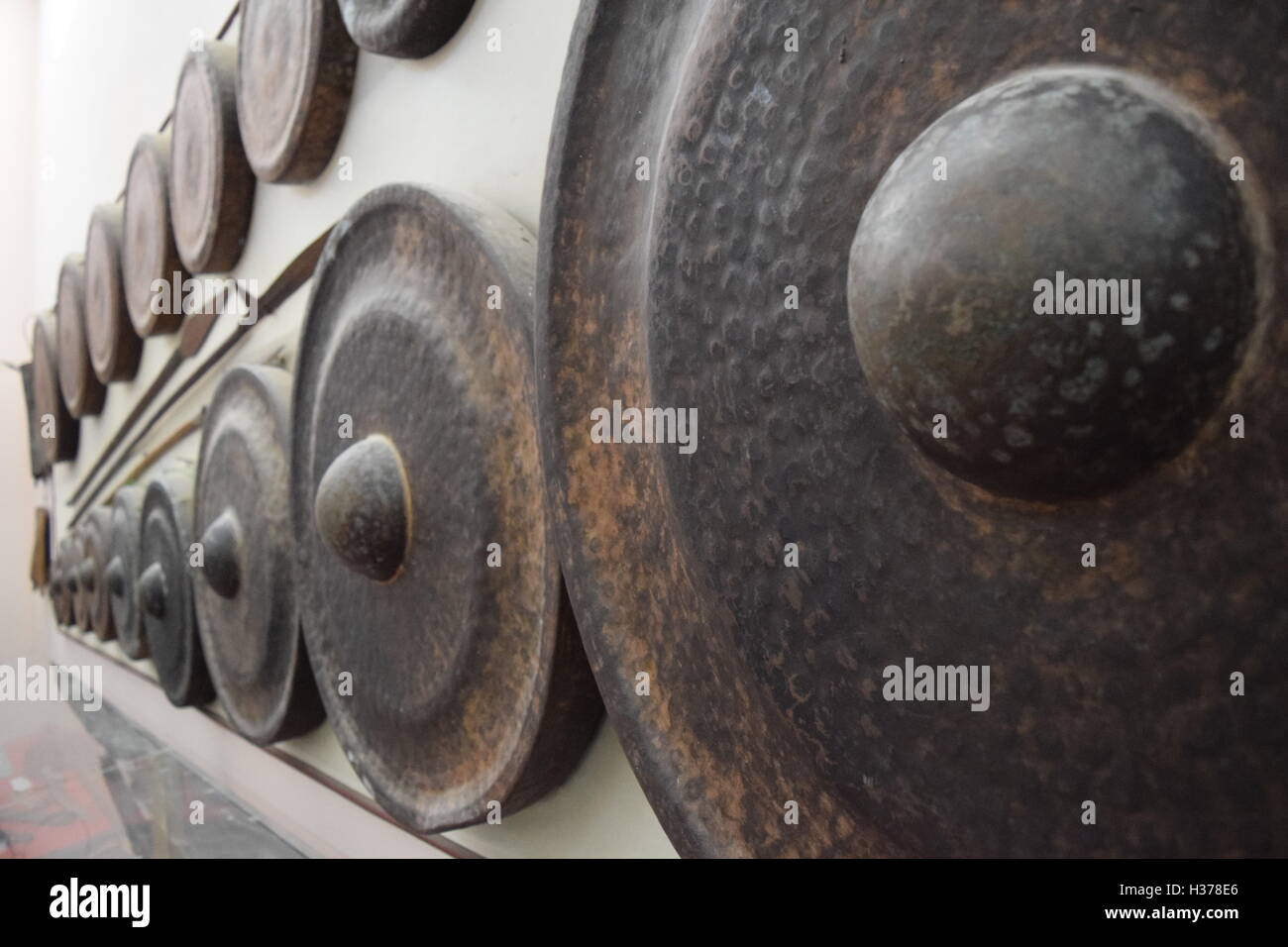 different kind of traditional gongs instrument and spear in museum of