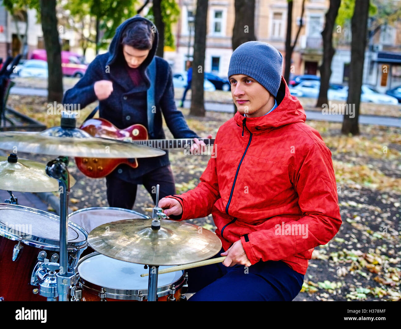 Male buskers on autumn park. Stock Photo