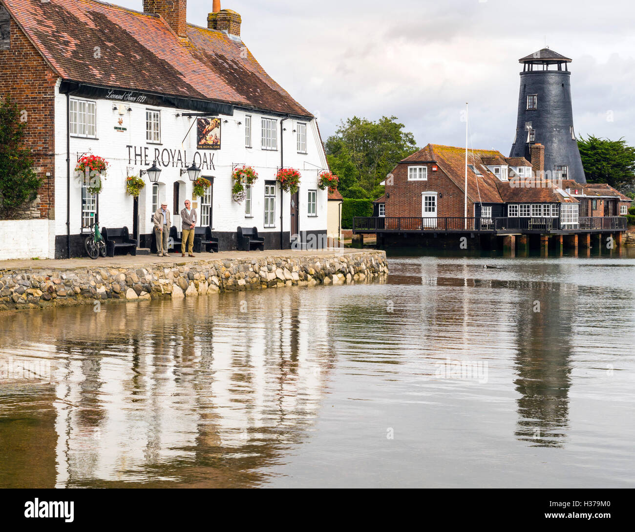 The Royal Oak public house, cottages and Windmill overlook Langstone Harbour, Havant, UK Stock