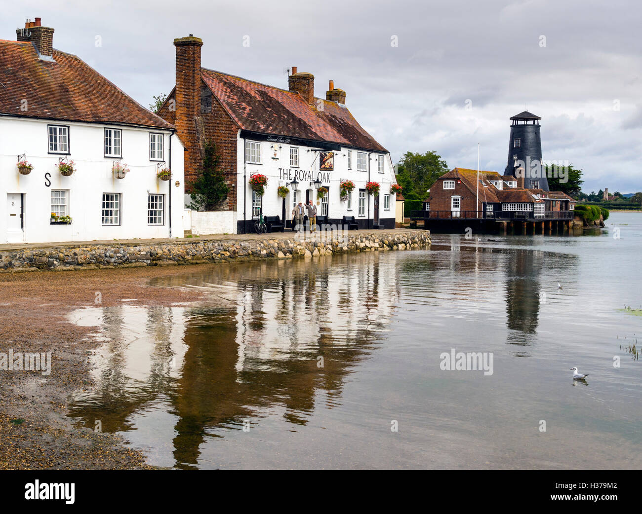 The Royal Oak public house, cottages and Windmill overlook Langstone