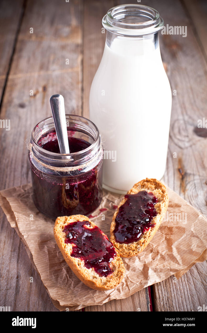 black currant jam in glass jar, milk and crackers Stock Photo Alamy