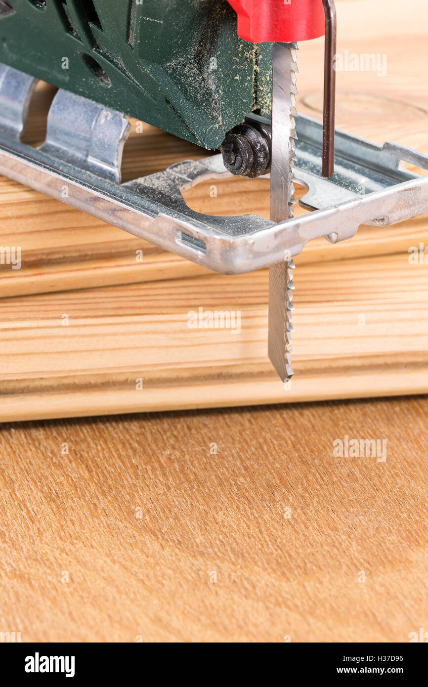Wood planks cutting with electric fret saw tool Stock Photo