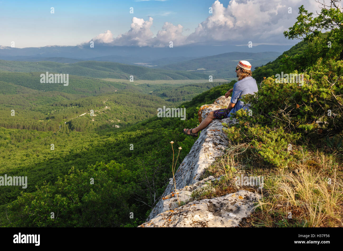 Hiking man in rays of sunset Stock Photo