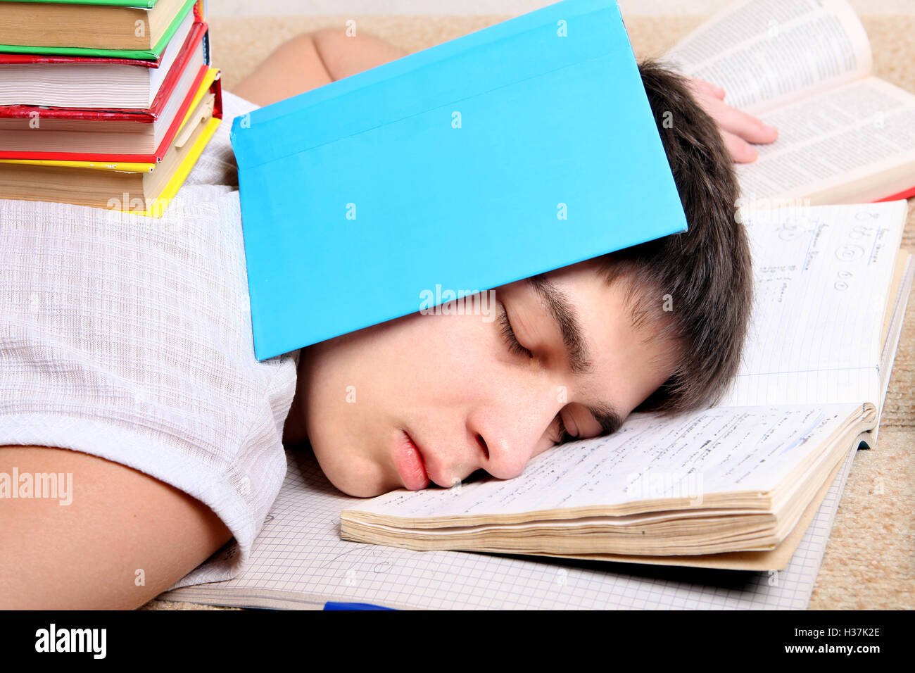 Teenager sleeps on the Books Stock Photo