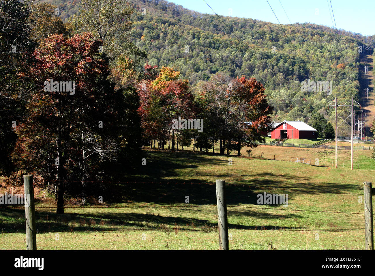 Land in rural Virginia, USA, with power lines going uphill Stock Photo Alamy