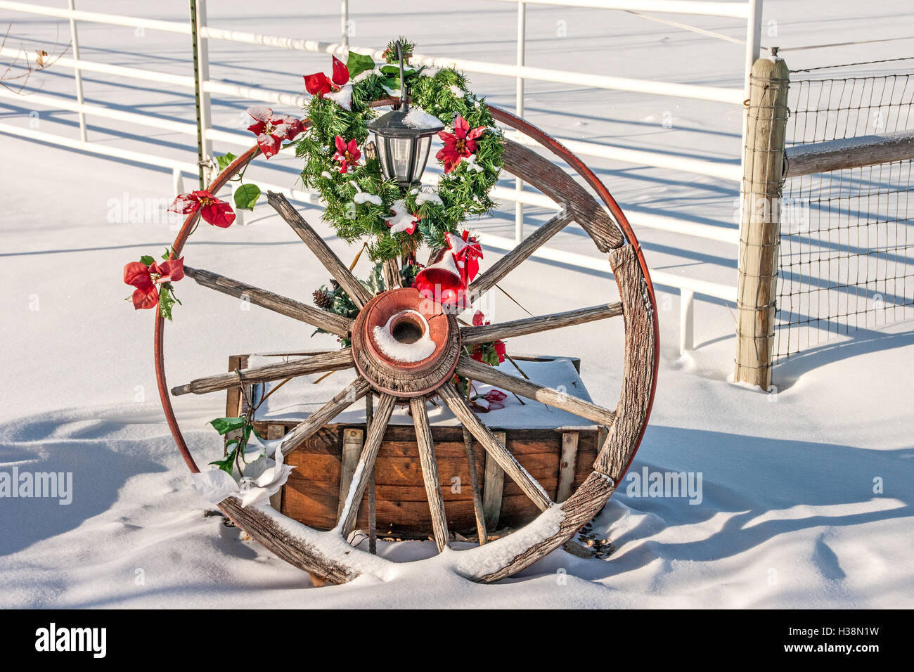Broken, rusty wagon wheel decorated for  Christmas Stock Photo
