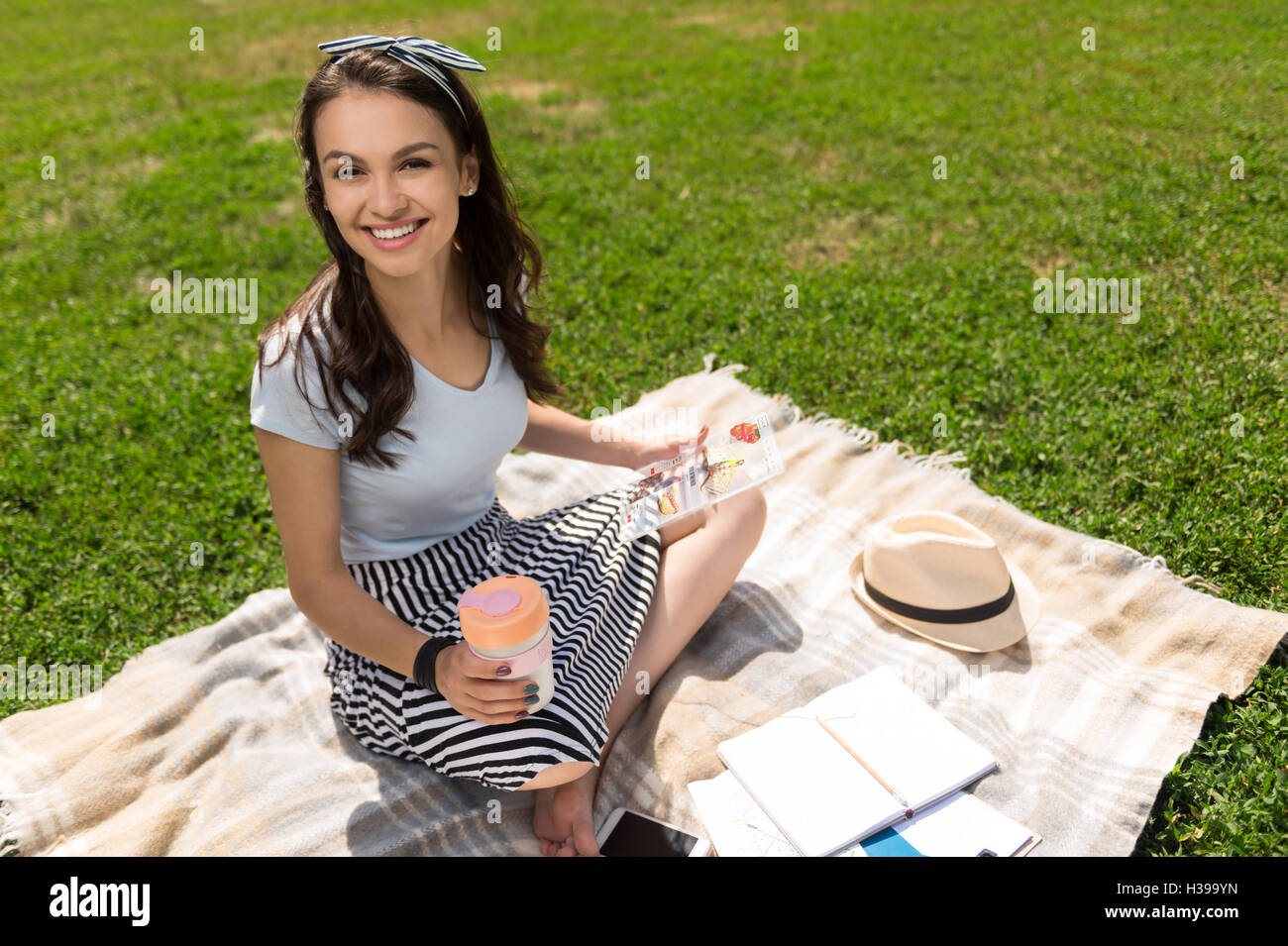 Positive smiling woman resting on the grass Stock Photo - Alamy