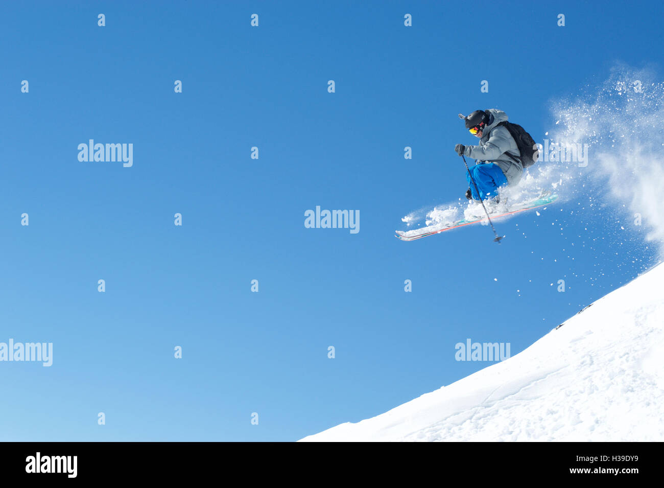 Freeskier flies through a blue sky Stock Photo