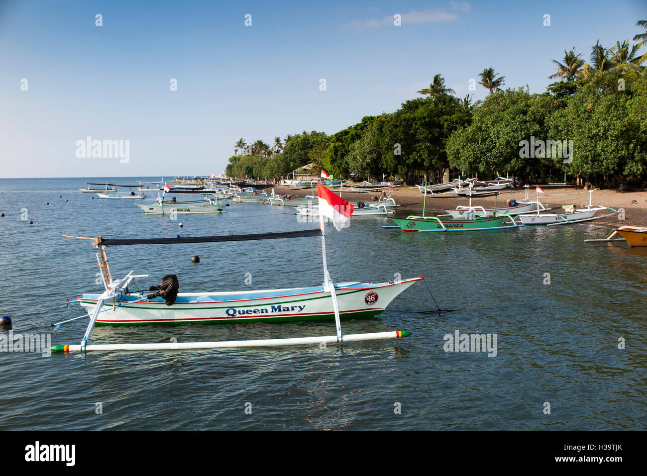 Indonesia, Bali, Lovina, fishing boats on main beach and moored in sea Stock Photo