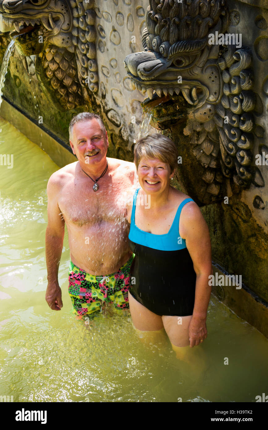 Indonesia, Bali, Banjar, Air Panas (volcanic Hot Spring) western tourist couple bathing in holy swimming pool Stock Photo