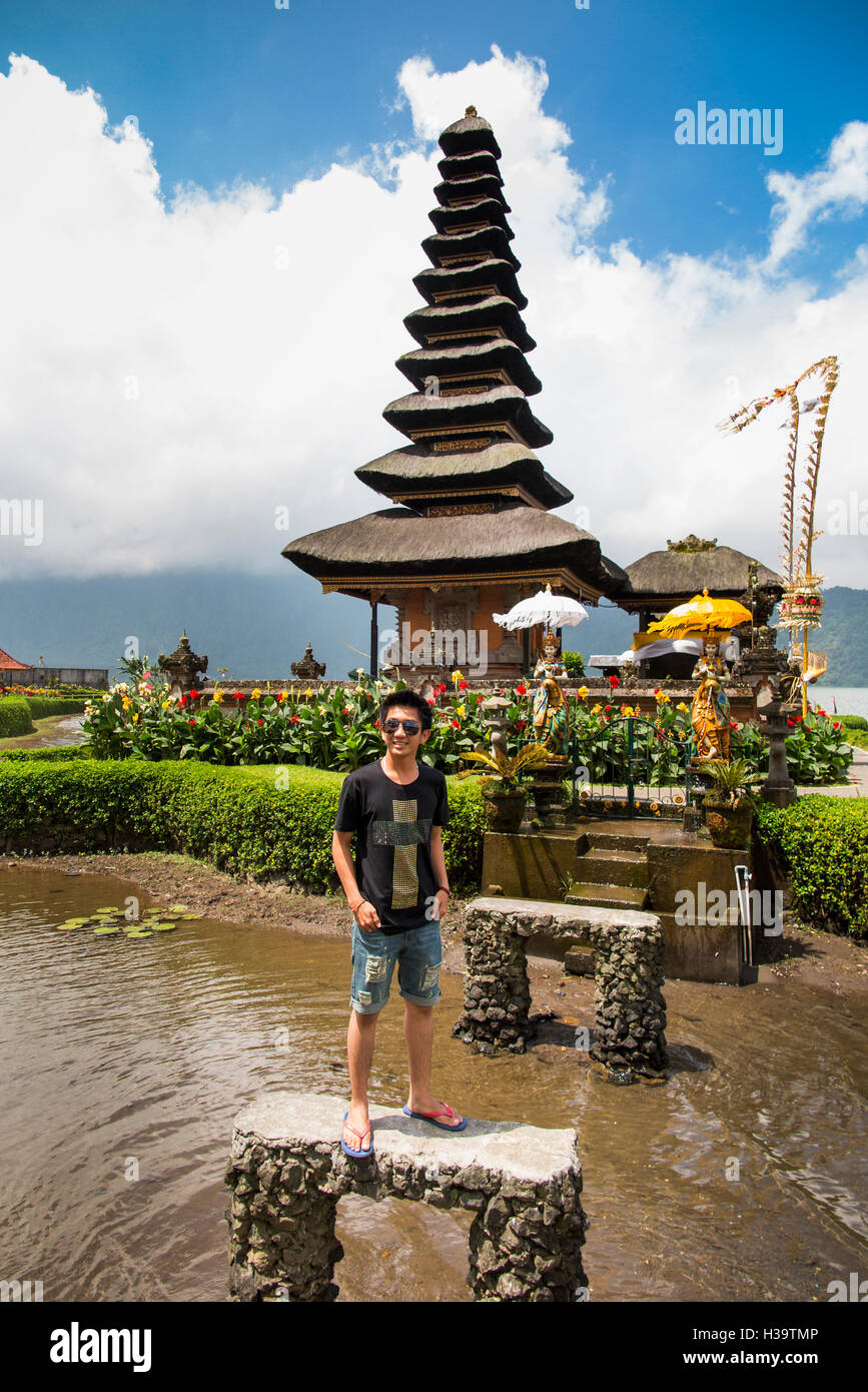 Indonesia, Bali, Candikuning Pura Ulun Danu Bratan temple, tourist posing for picture at pagoda on lake Stock Photo