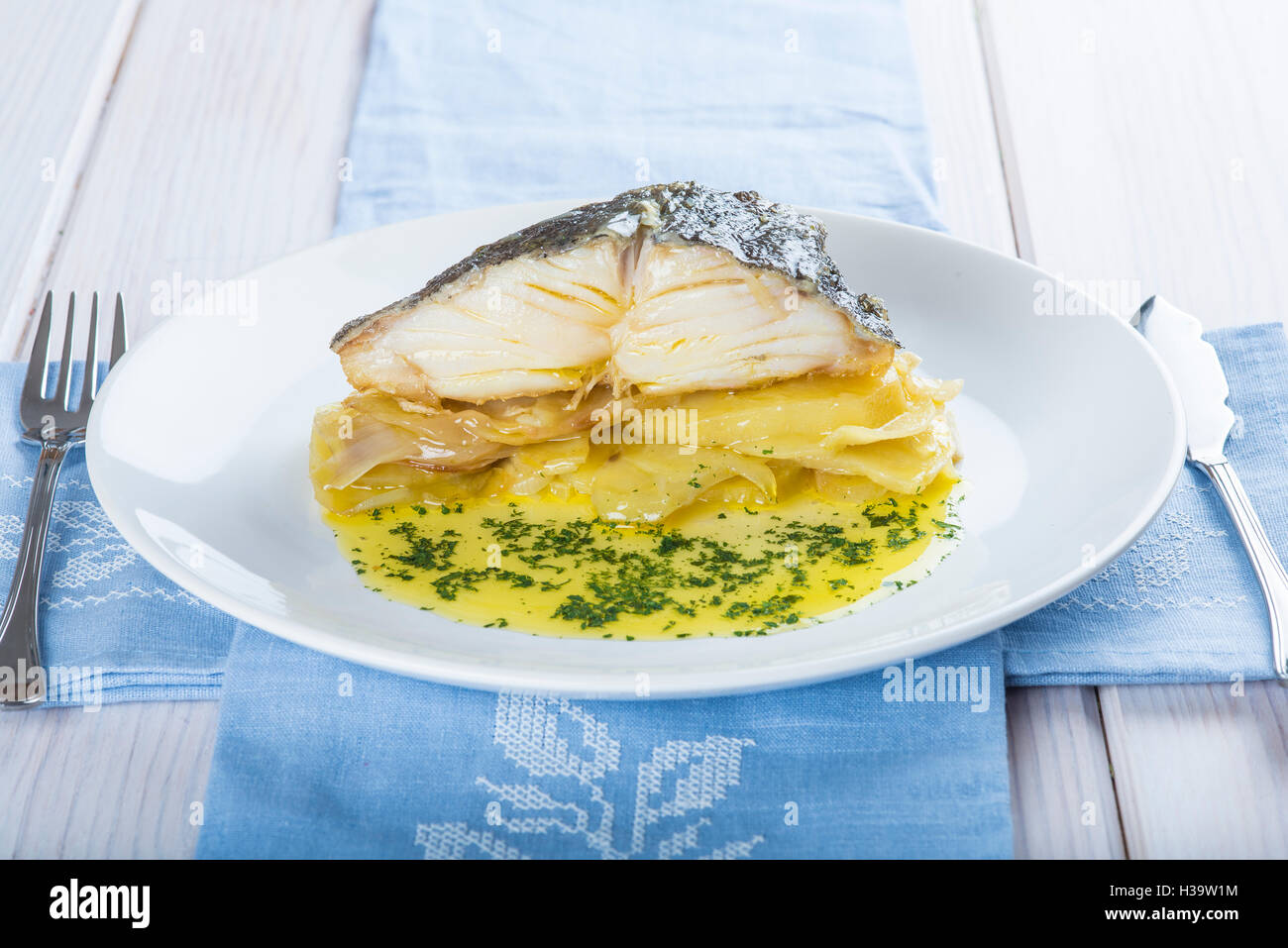 Salted cod fish oven baked with potatoes onion and olive oil Stock Photo Alamy