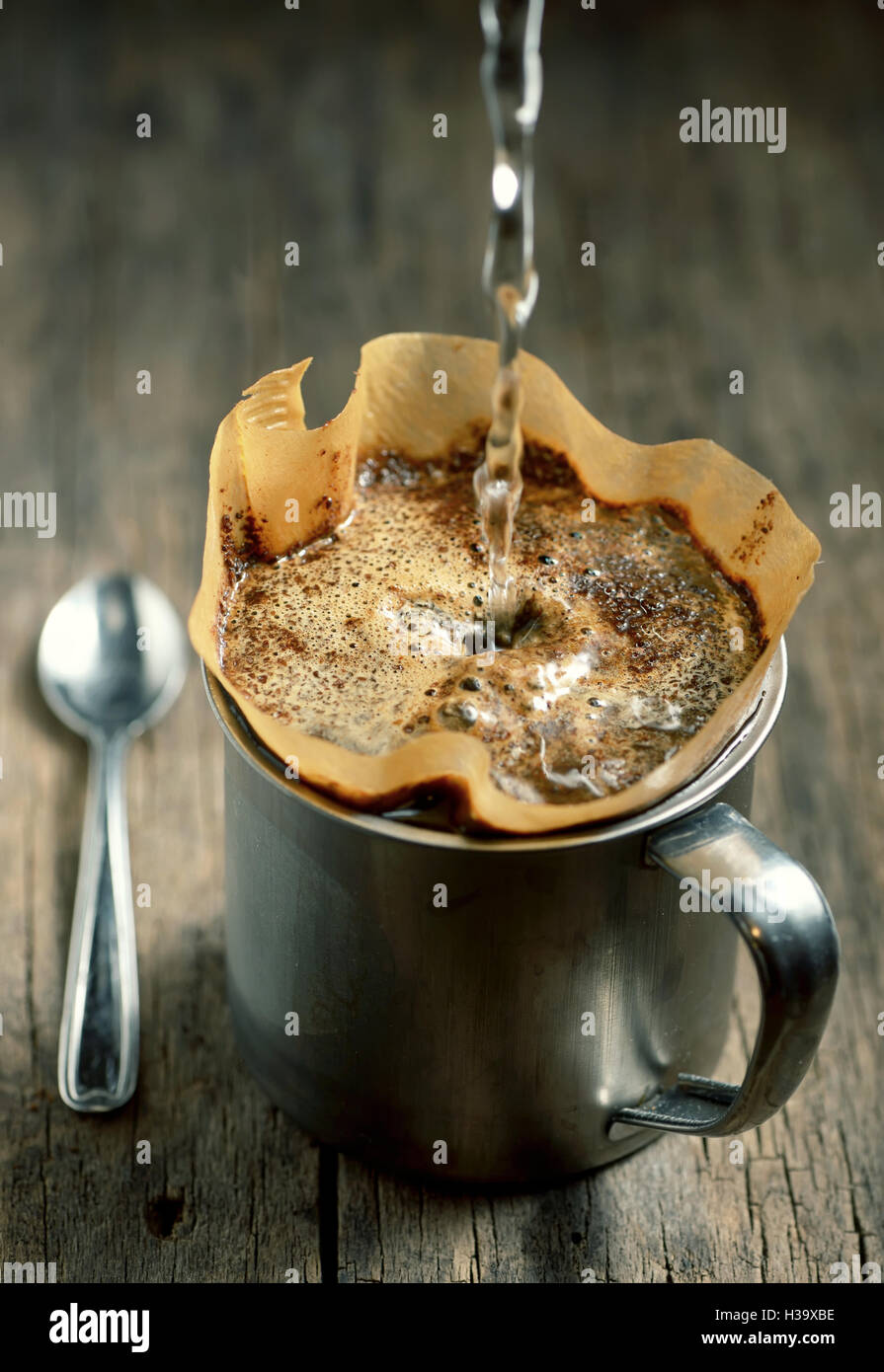 Ground coffee in filter holder isolated on wooden background Stock