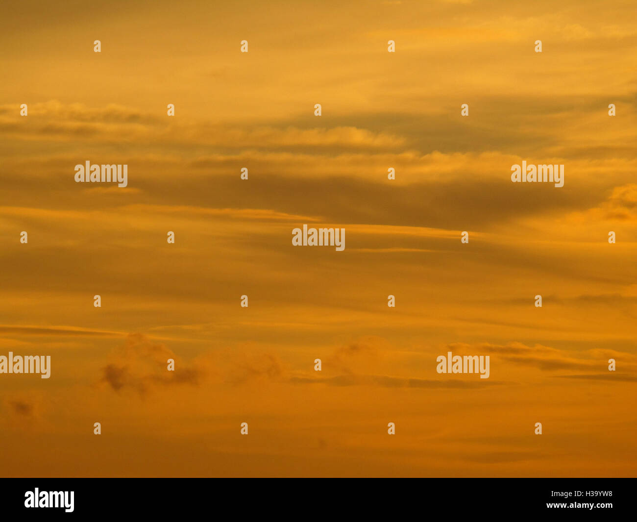Beautiful golden after sunset cloudy sky, background Stock Photo - Alamy