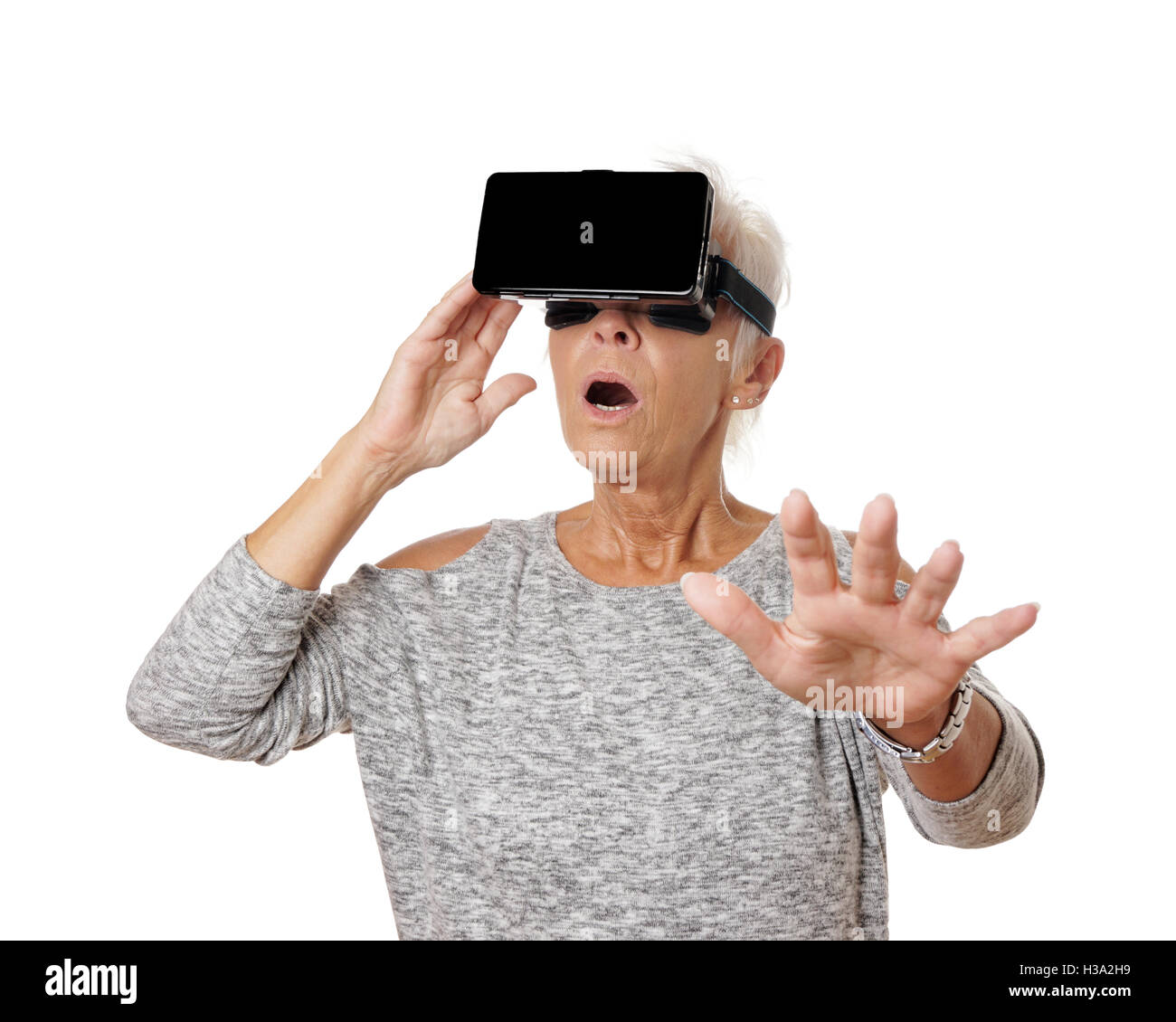 senior woman with VR virtual reality headset is stunned Stock Photo