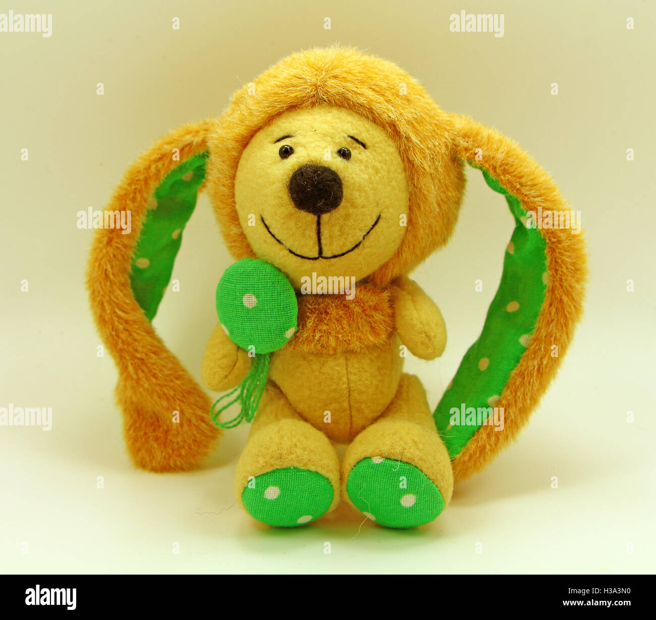 cute toy rabbit, yellow background, handmade toys, fluffy ears, smiling face, easter rabbit