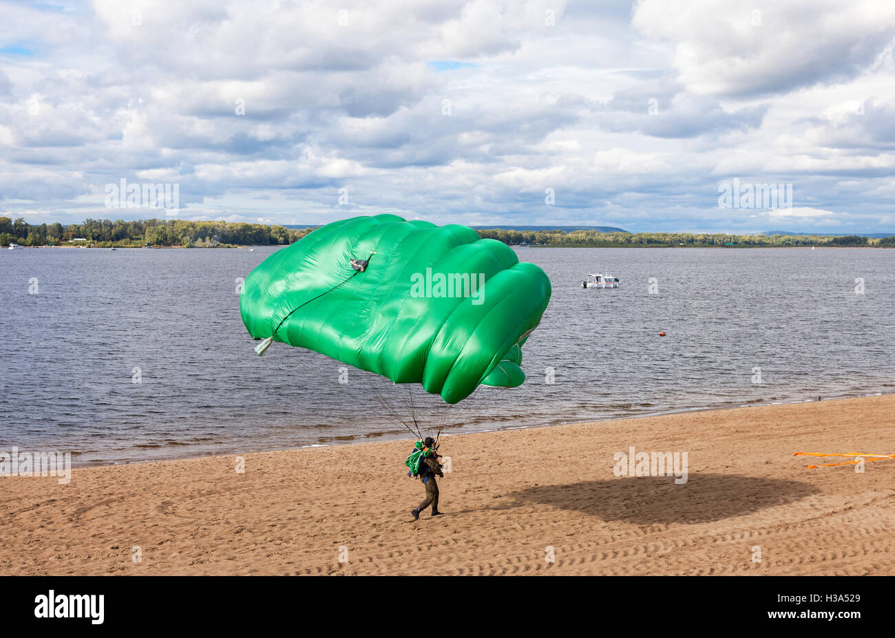 Parachute jumper on a  wing parachute execute a controlled descent by parachute on a beach Stock Photo