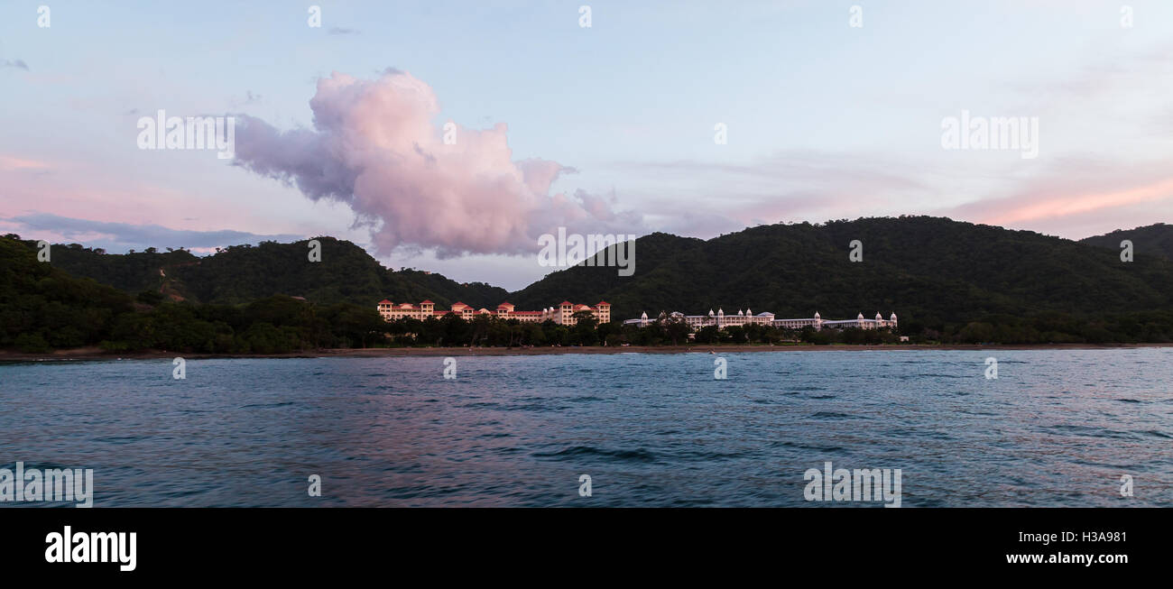 Panorama captured at dusk of the Riu Guanacaste & the Riu Palace Costa Rica surrounded by a dry forest. Stock Photo