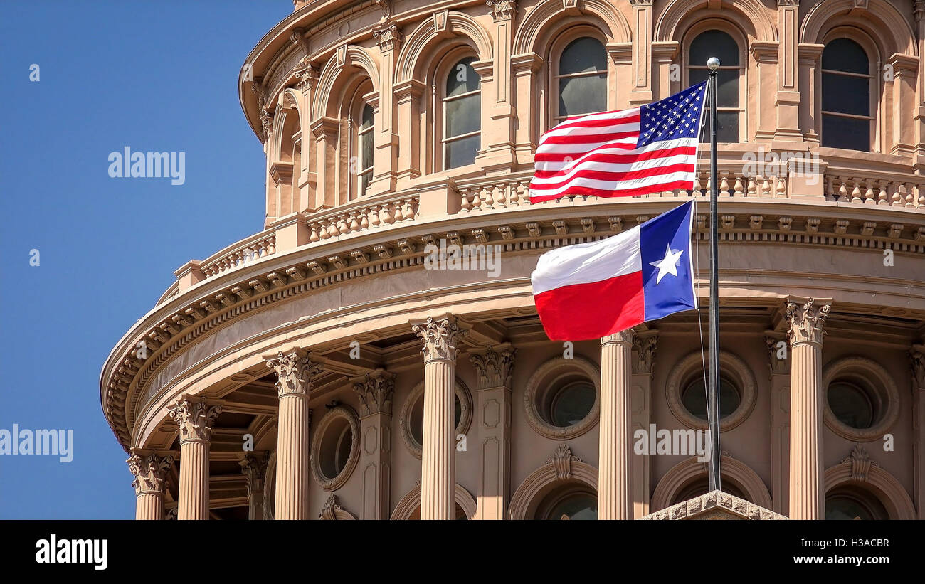 American and Texas state flags flying on the dome of the Texas State Capitol building in Austin Stock Photo