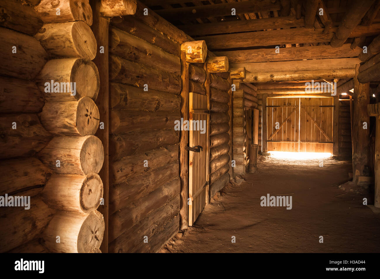 Ancient rural Russian interior, corridor with walls made of rough logs and glowing end Stock Photo