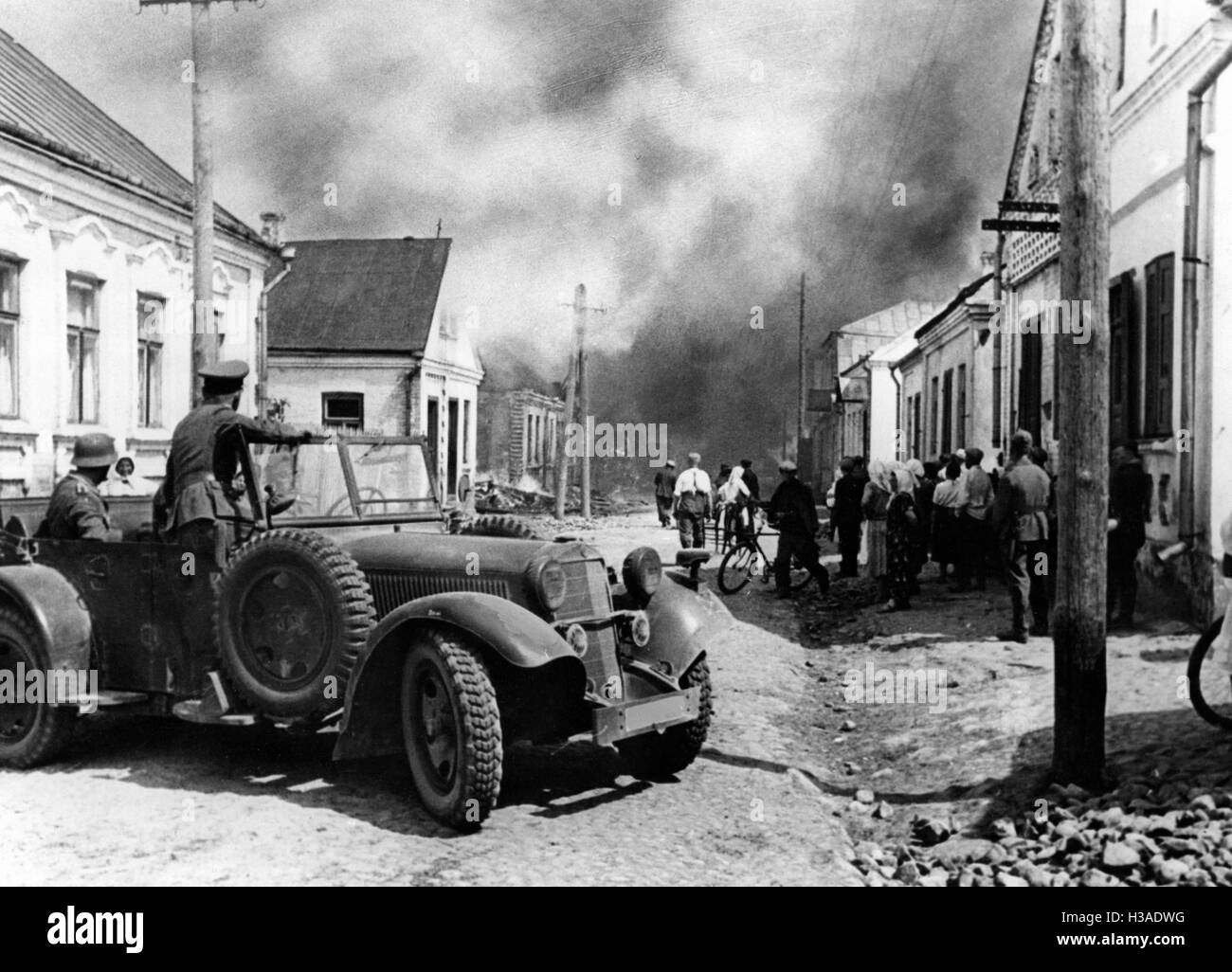 Vehicle of the Wehrmacht in a burning Russian village, 1941 Stock Photo