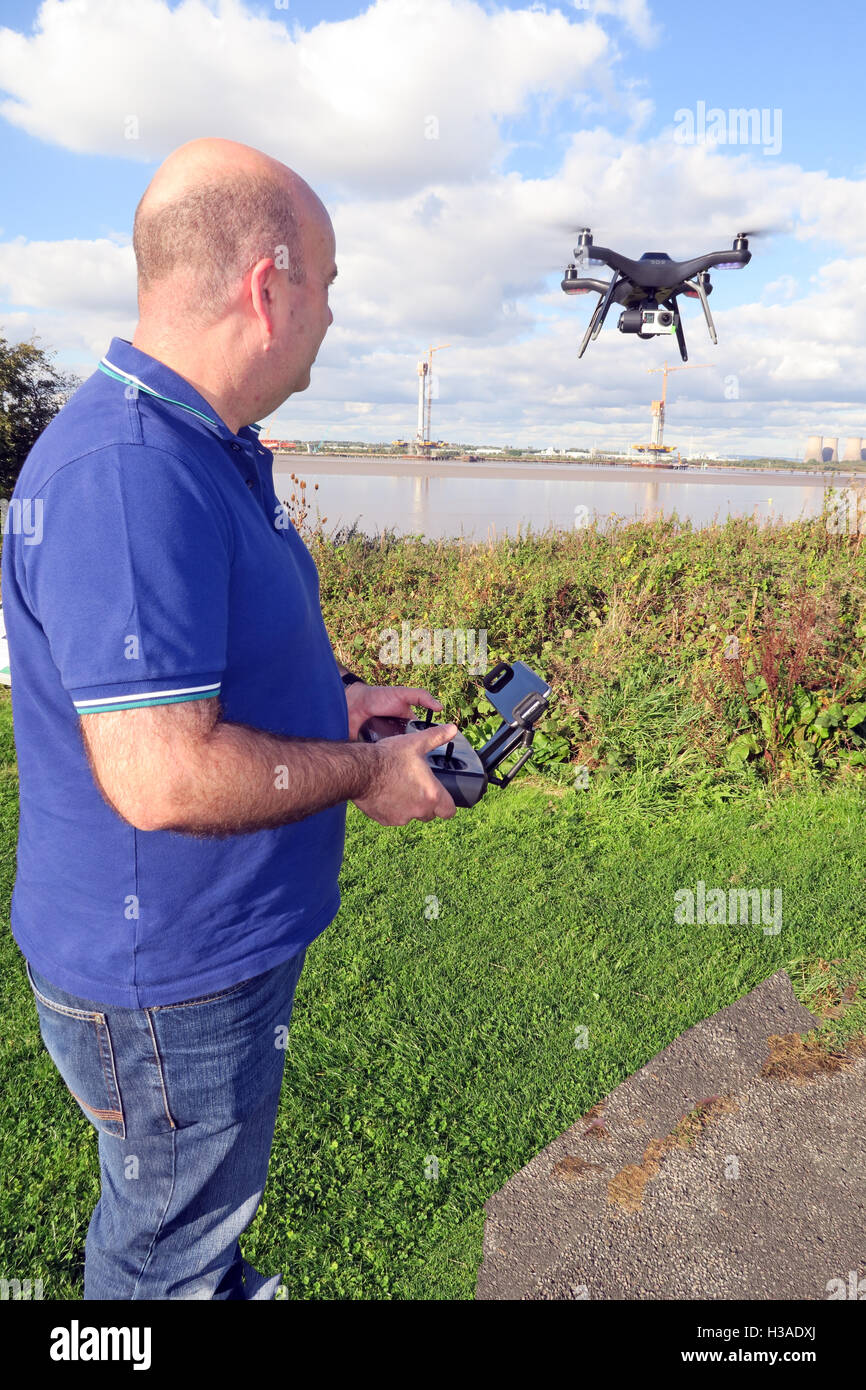 Man flying 3DR RTF X8 drone near River Mersey, Merseyside, England Stock Photo