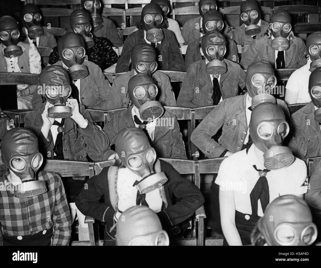 Jungmaedels learn to put on a gas mask, 1939 Stock Photo