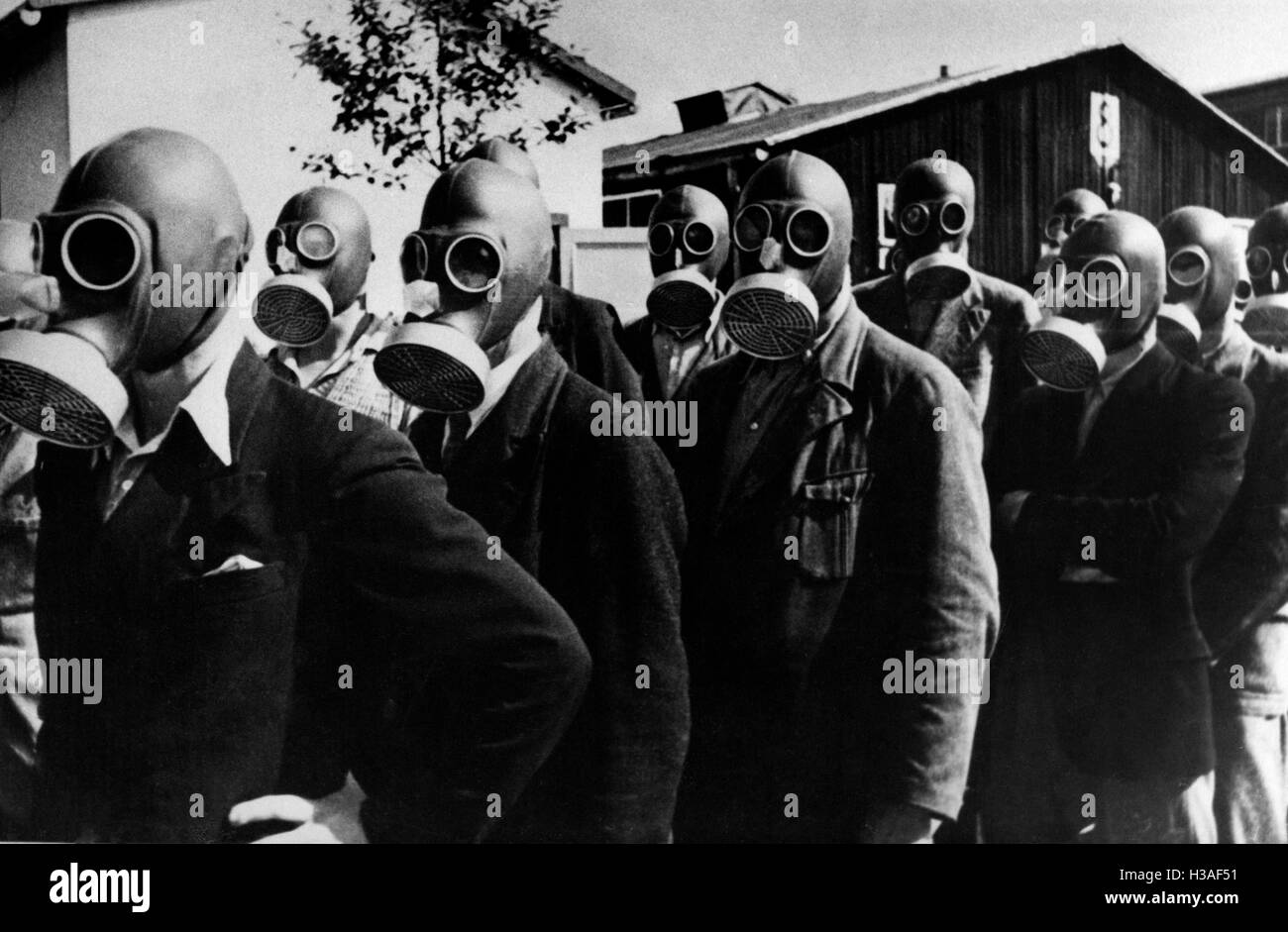 Factory workers testing Volksmasken (civilian gas masks), 1938 Stock Photo