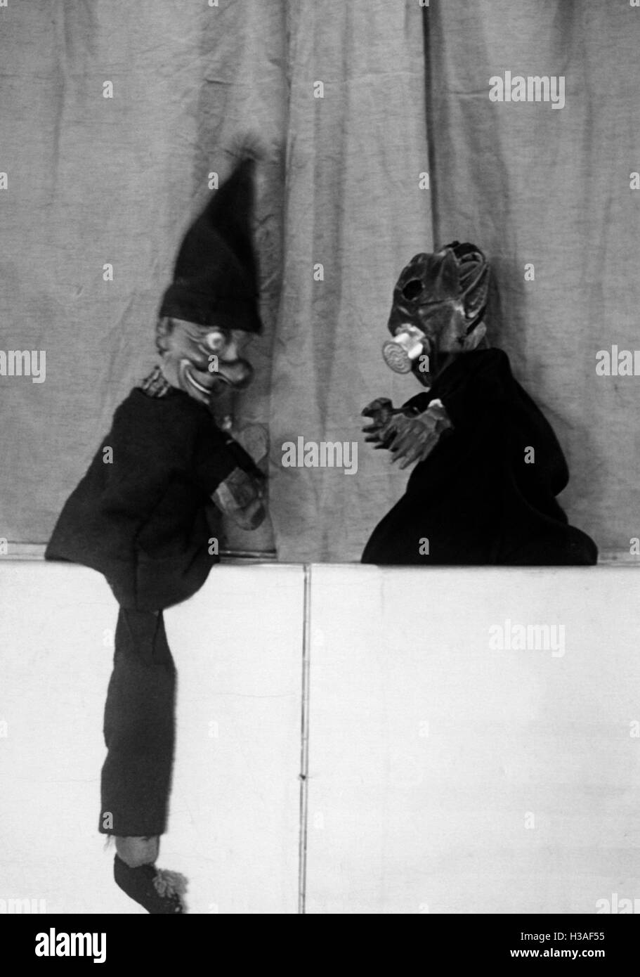 Hand puppet show with gas mask, 1933 Stock Photo