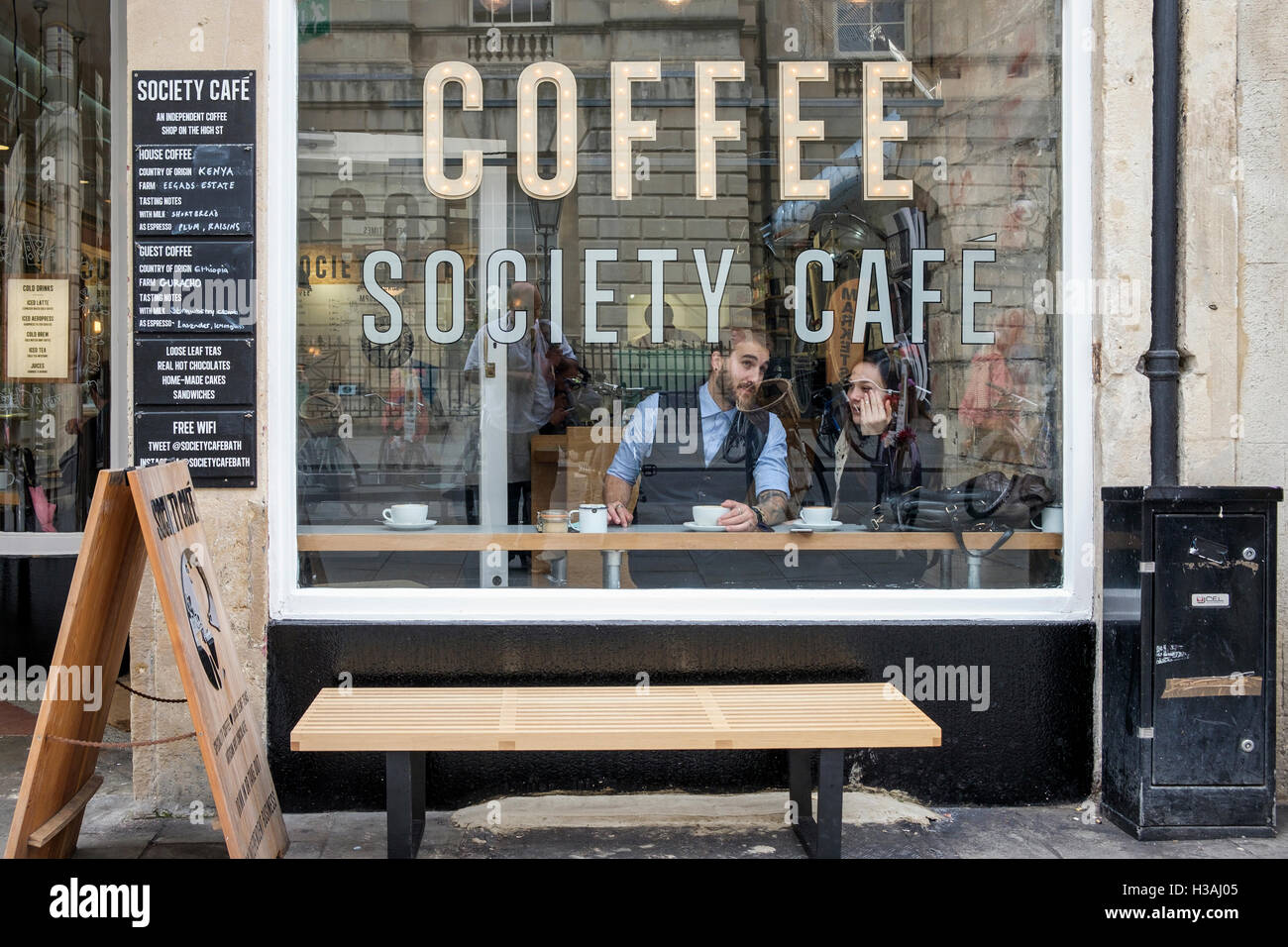 People drinking coffee are pictured sitting inside a coffee cafe in Bath,England,UK Stock Photo