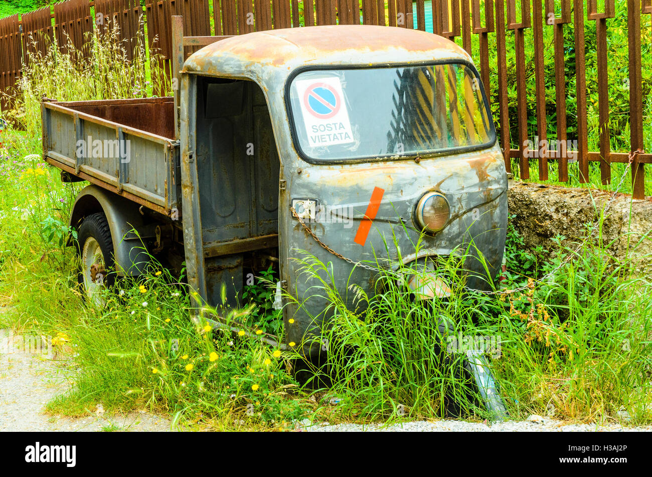 Abandoned three-wheel truck in the town of Montalbano Elicona in the Province of Messina, Sicily, Italy Stock Photo