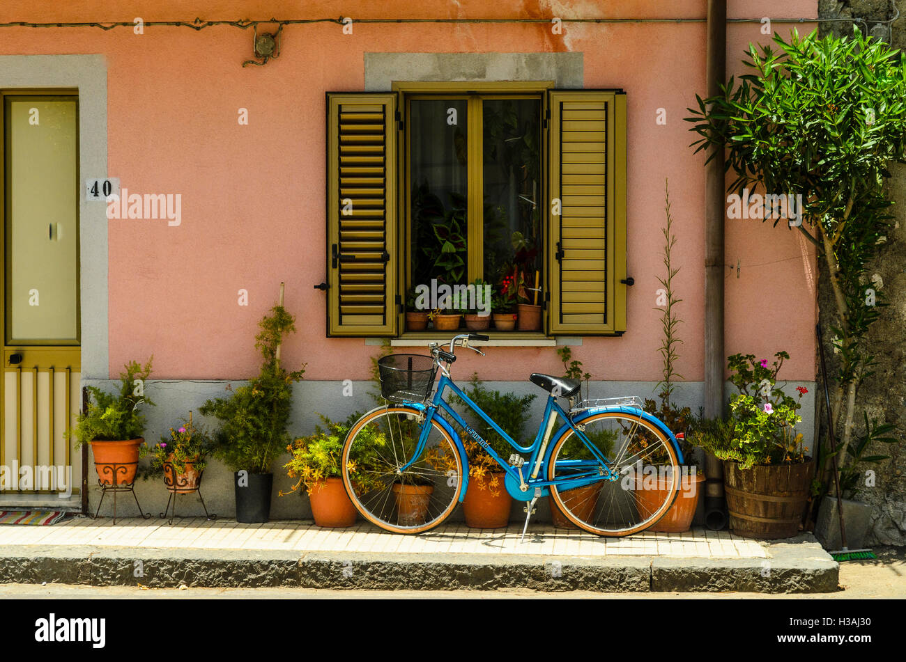 Bike outside house in the town of Mojo Alcantara in the Province of Messina, Sicily, Italy Stock Photo