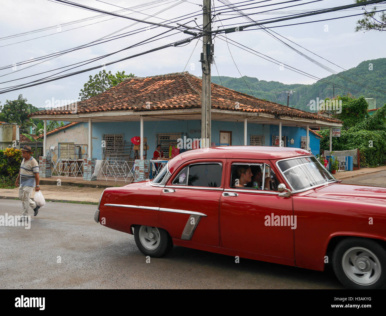 City center on Vinjales Cuba where streets intersects. People are walking driving cars and riding bikes. Stock Photo