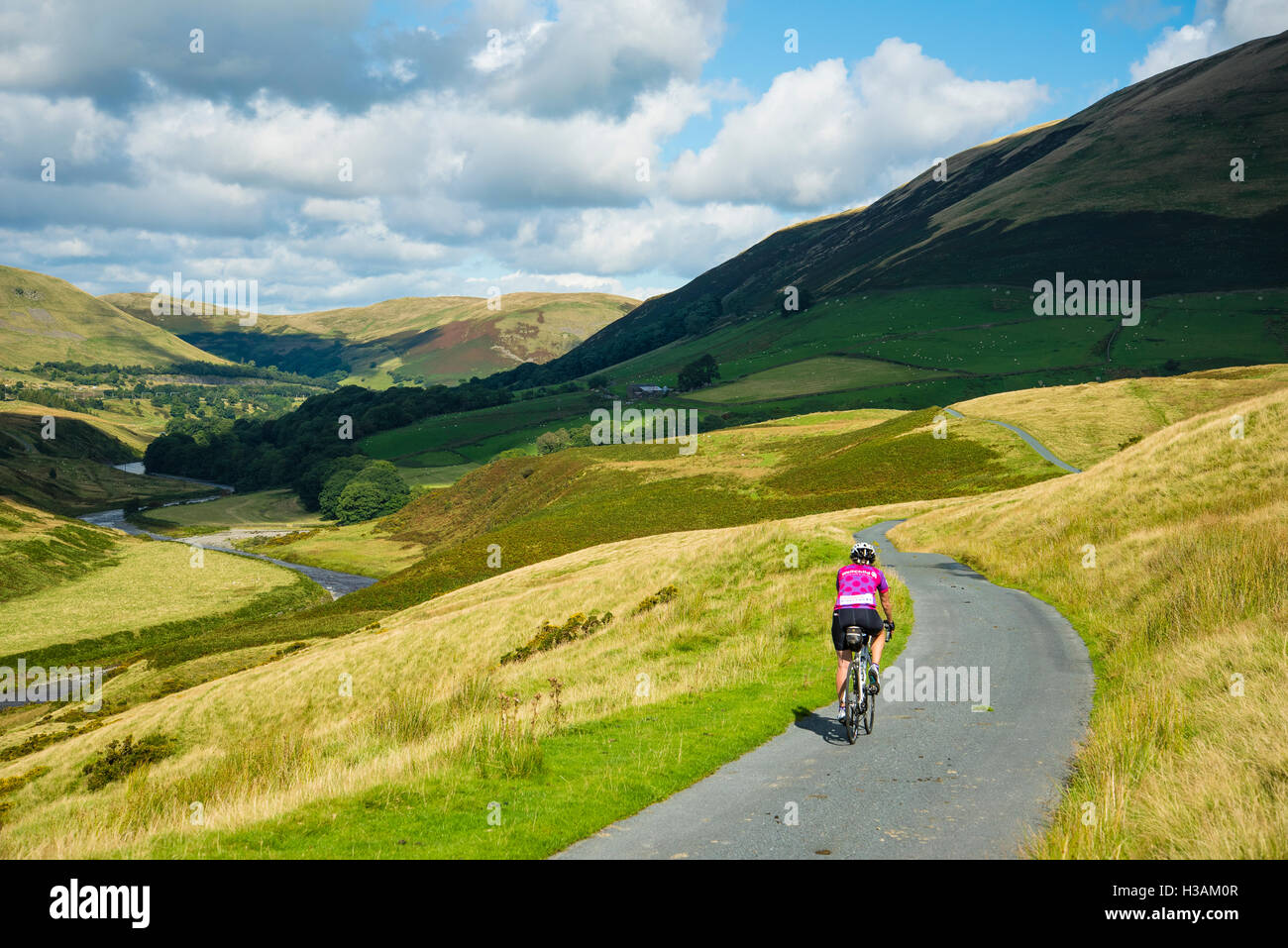 Female cyclist on Fairmile Lane in the Lune Gorge Cumbria England UK Stock Photo