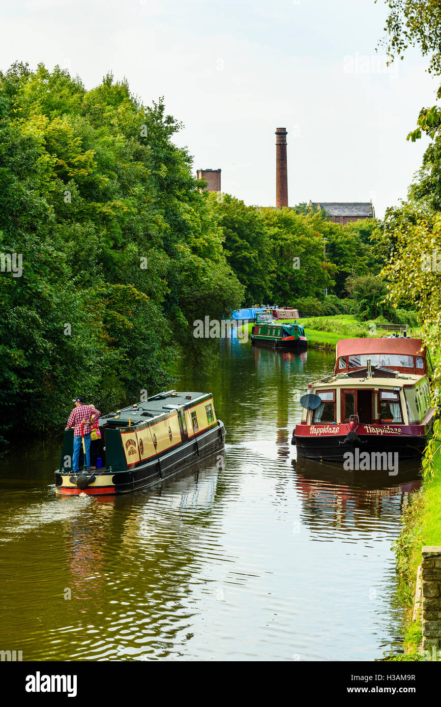 Narrowboats on the Leeds and Liverpool Canal just outside Burscough in West Lancashire England UK looking towards Ainscough Mill Stock Photo