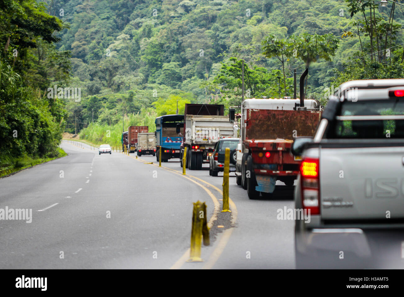Trafic jam in the road ade by slow industrial trucks Stock Photo - Alamy