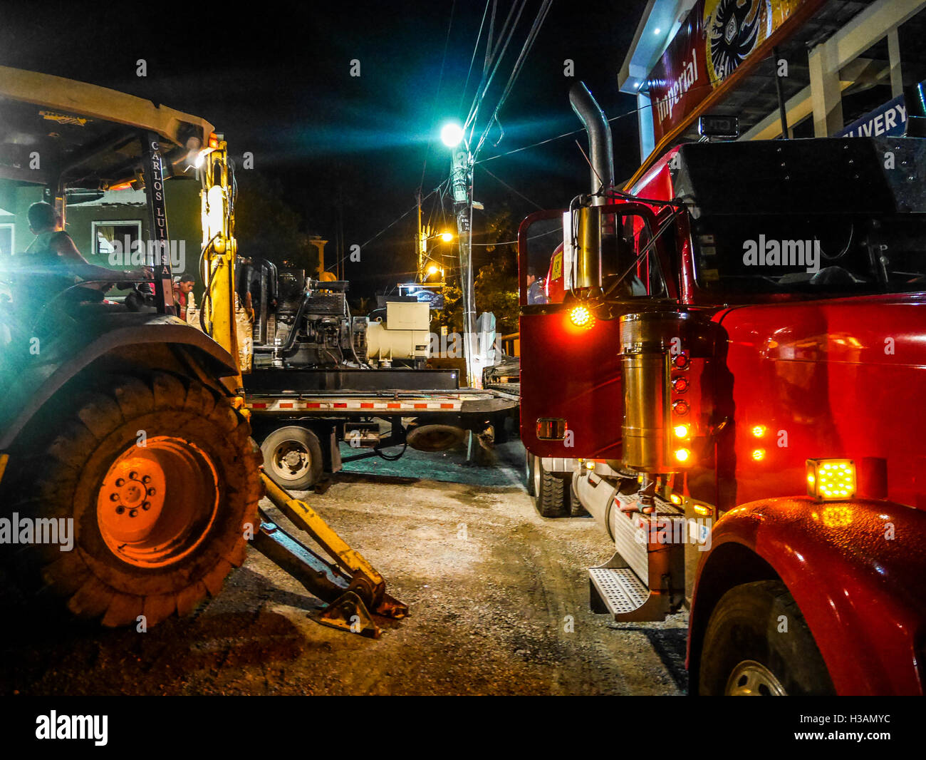 Night shift for truck drivers loading heavy truck with a crane in Costa