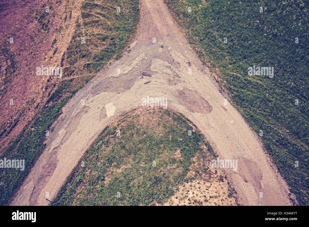 Vintage toned dirt road crossroads seen from above, conceptual picture. Stock Photo