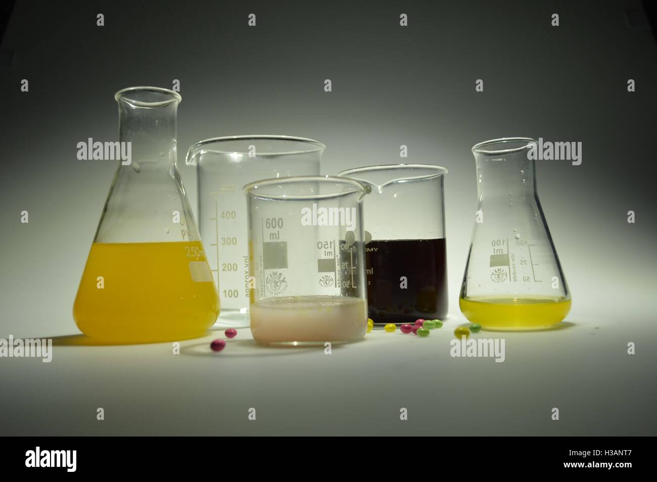 Science lab with colourful liquid chemicals in beakers, flasks and jugs