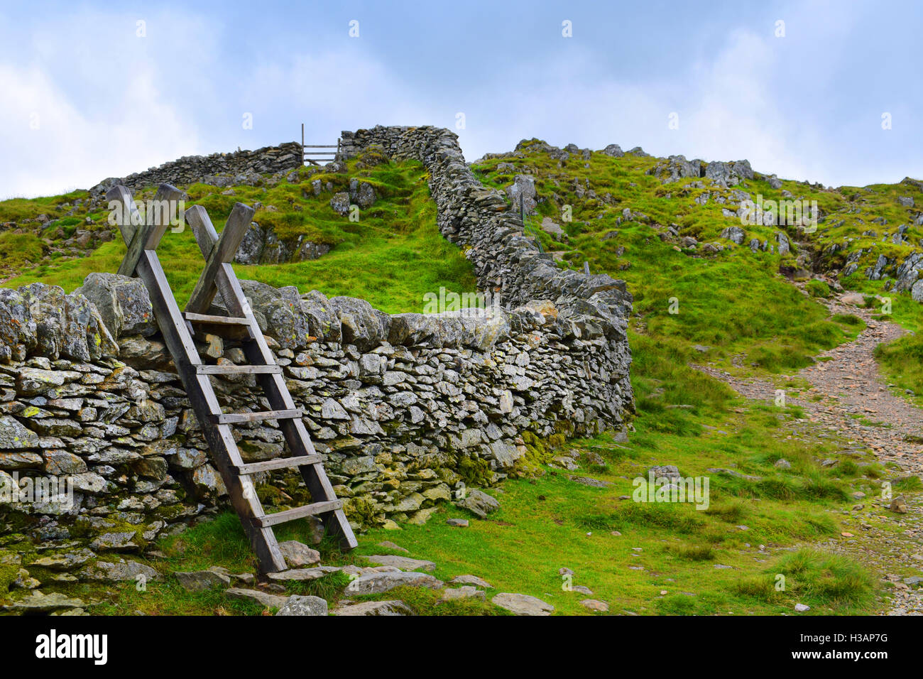 wooden stile over dry stone wall in the countryside Stock Photo Alamy