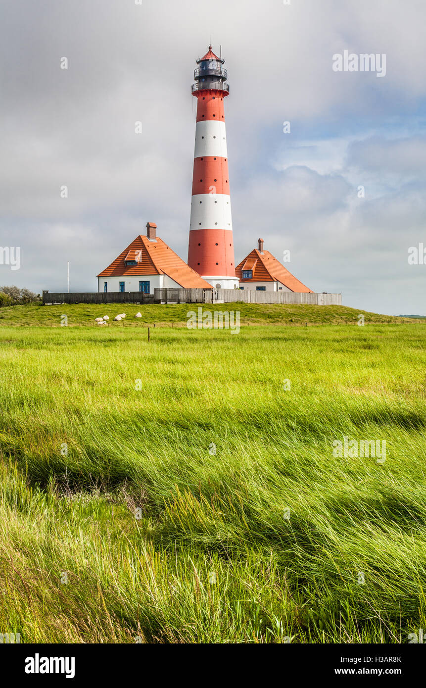 Beautiful coastal landscape with traditional lighthouse in the background at North Sea in Nordfriesland, Schleswig-Holstein, Ger Stock Photo