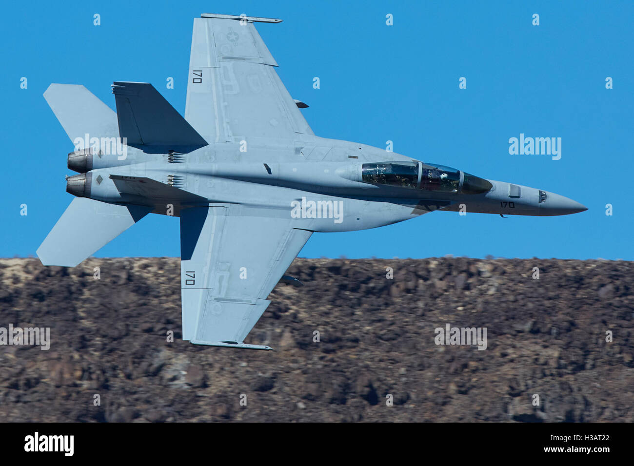 United States Navy F/A-18F Super Hornet Jet Fighter, Rolling Into Rainbow Canyon. Stock Photo