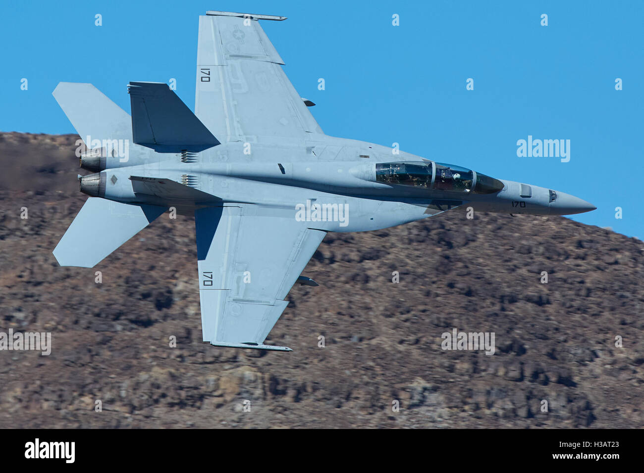 United States Navy F/A-18F Super Hornet Jet Fighter, Rolling Into Rainbow Canyon. Stock Photo