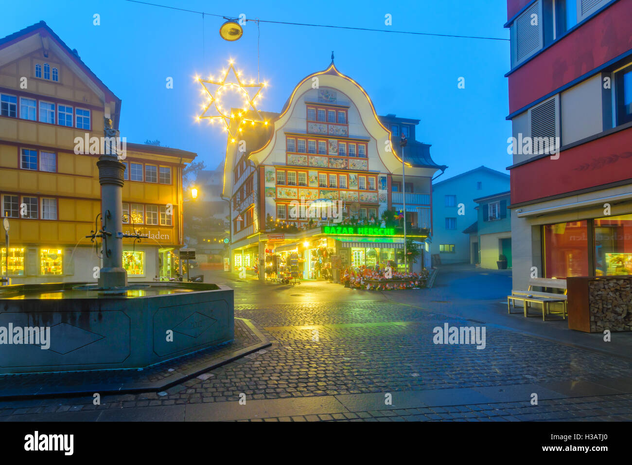 APPENZELL, SWITZERLAND - DECEMBER 30, 2015: Evening scene with painted houses, Christmas decorations, locals and visitors, in Ap Stock Photo