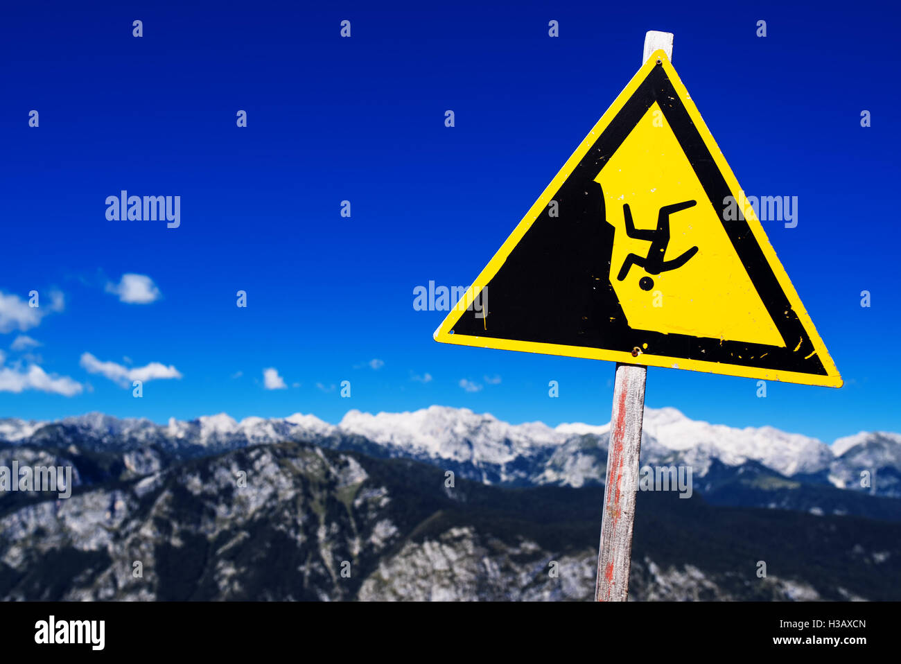 Warning sign - possible fall from the mountain cliff, Julian Alps in the background Stock Photo