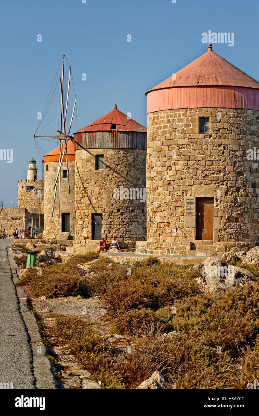Old windmills at Rhodes city harbour, Island of Rhodes, Dodecanese island group, Greece. Stock Photo