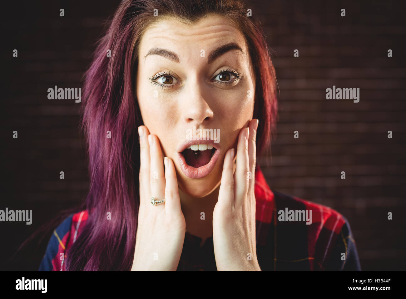 Young woman making a surprised facial expression Stock Photo